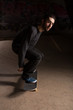 Skater bending his knees to prepare for a trick