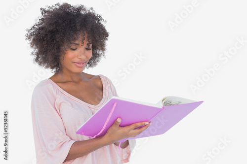 Photo: Beautiful woman looking at photo album Beautiful woman looking at photo album