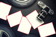 Blank card with car tire on carbon fiber background.