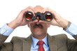 The businessman looks in the binoculars