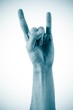 Photo: A man's hand giving the Rock and Roll sign isolated on a white b A man's hand giving the Rock and Roll sign isolated on a white b