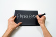 two hand writing problems on a black background
