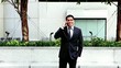 Handsome hispanic businessman talking at phone