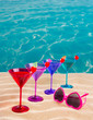 colorful cocktail in a row with cherry on tropical sand beach