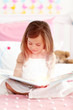 Little girl reading a storybook