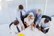 Five architects working on blueprints