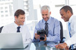 Business men looking at a camera