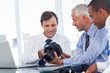 Business men interested by a camera