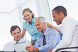 Business team watching a tablet computer