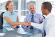 Business man and business woman shaking hands