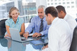 Business people using a laptop and digital tablet