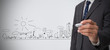 Businessman drawing out a town plan doodle