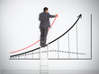 Businessman standing on ladder drawing large graph