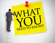 Businessman standing on ladder writing what you need to know