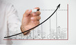 Businessman drawing graph over town doodle