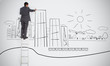 Businessman drawing skyscrapers on town doodle