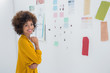 Cute designer standing in front of material samples