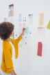 Female designer standing in front of material samples