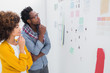 Thoughtful designers standing in front of material samples