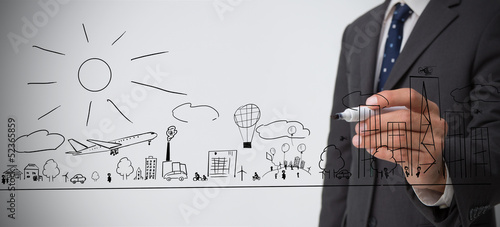 Photo: Businessman drawing a town Businessman drawing a town