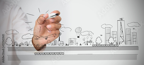 Photo: Businessman drawing a cityscape Businessman drawing a cityscape