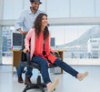 Creative business colleagues having fun on an office chair