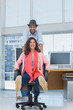 Photo editors having fun on a swivel chair
