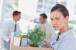 Unhappy businesswoman leaving office after being let go