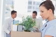 Annoyed businesswoman leaving office after being let go