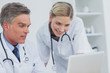 Two doctors watching a laptop