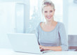 Smiling woman using her laptop