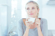 Delighted woman holding a cup