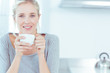 Radiant woman drinking a cup of tea