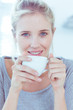 Smiling woman holding a cup of tea