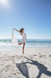Attractive woman jumping with sarong