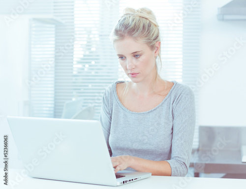 Photo: Pretty woman using her laptop Pretty woman using her laptop