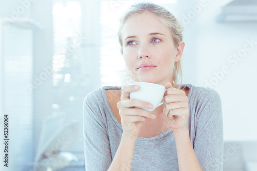 Photo: Delighted woman holding a cup Delighted woman holding a cup