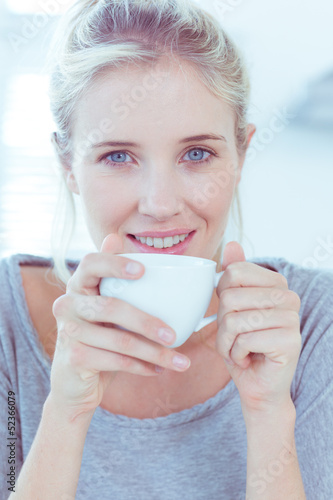 Photo: Smiling woman holding a cup of tea Smiling woman holding a cup of tea