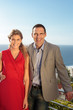 Couple gesturing in front of the camera on balcony