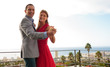 Delighted couple dancing on the balcony