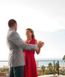 Lovely couple dancing together on the balcony