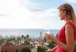 Attractive woman looking the view from her balcony