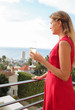 Woman holding a glass of champagne and watching the city centre