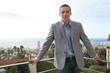 Handsome man leaning on balcony
