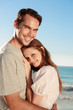 Smiling couple relaxing on the beach