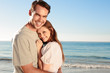 Cheerful couple relaxing on the beach during  summer