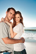 Young couple embracing and posing on the beach 