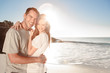 Couple embracing and posing on the beach 