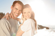Cheerful couple embracing on the beach 