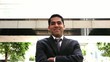 handsome businessman walking and smiling to the camera